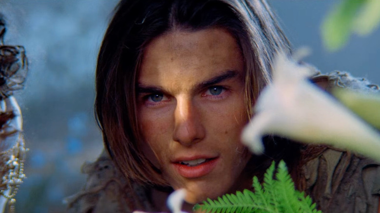 Tom Cruise as Jack peeking through some leaves in Legend (1985)