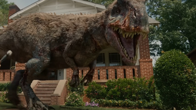 Ewan McGregor as Greg Platt getting ready to fighht an Allosaur with a hammer in The End of Oak Street