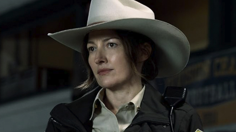 Kelly Macdonald's Kerry Kane is seen standing outside in Lanterns wearing a cowboy hat