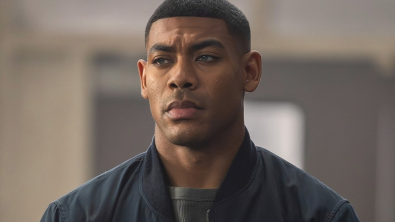Aaron Pierre as John Stewart standing in a courtroom in Lanterns