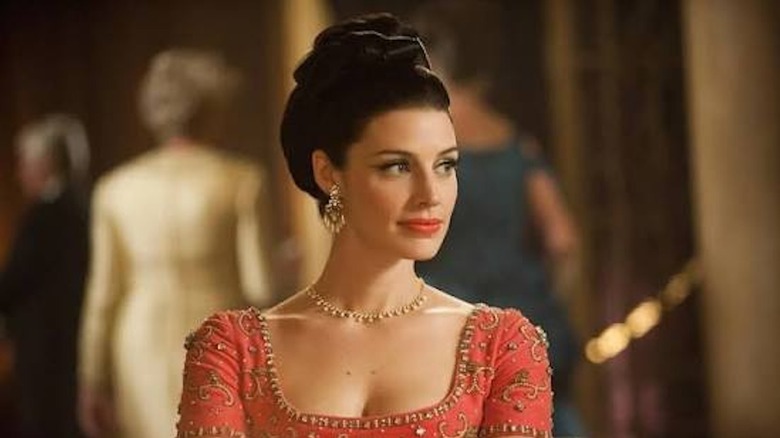 Jessica Paré looks stunning as Megan Calvet Draper seated in a restaurant in Mad Men