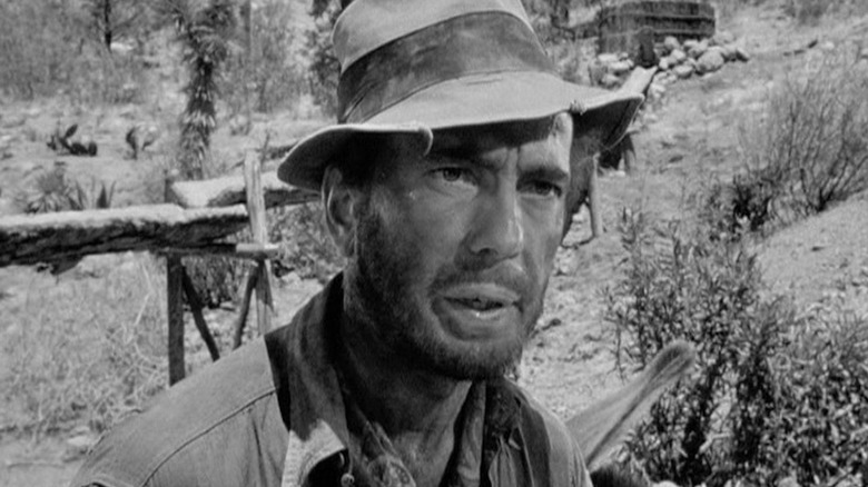 Fred C. Dobbs (Humphrey Bogart) stares suspiciously in The Treasure of the Sierra Madre