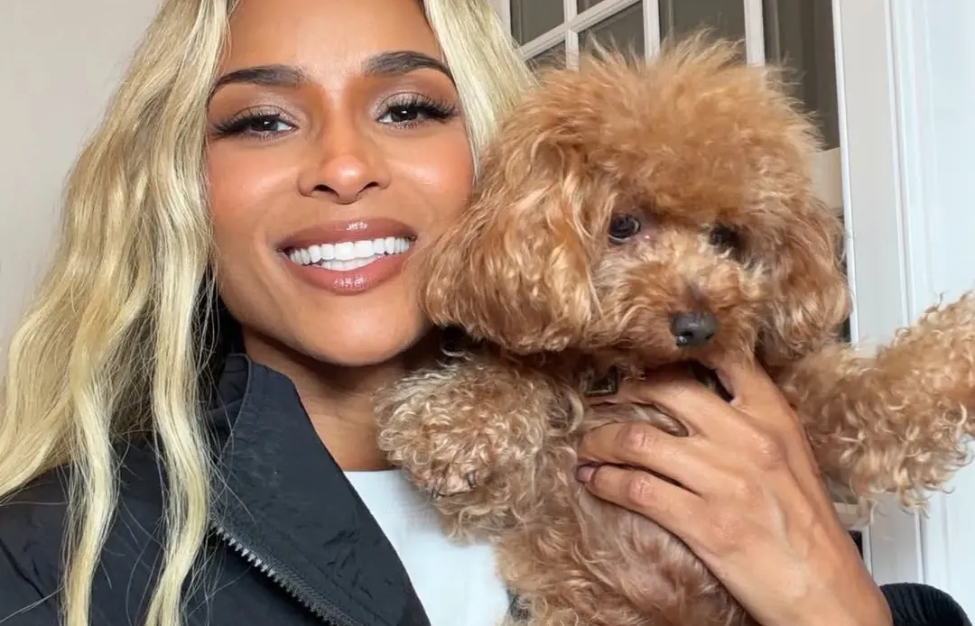 Ciara holding her small brown dog.