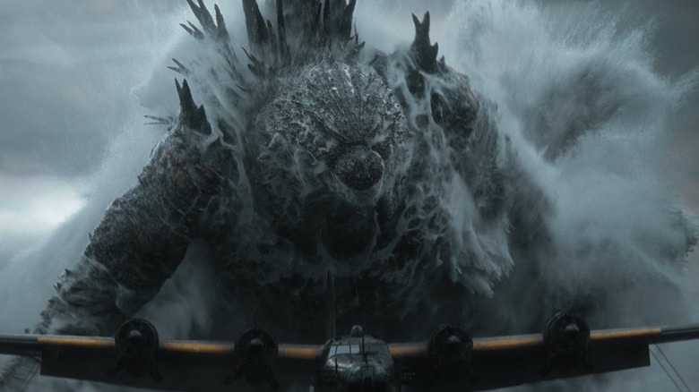 Godzilla as Godzilla emerging from the ocean behind an airplane in Godzilla Minus Zero