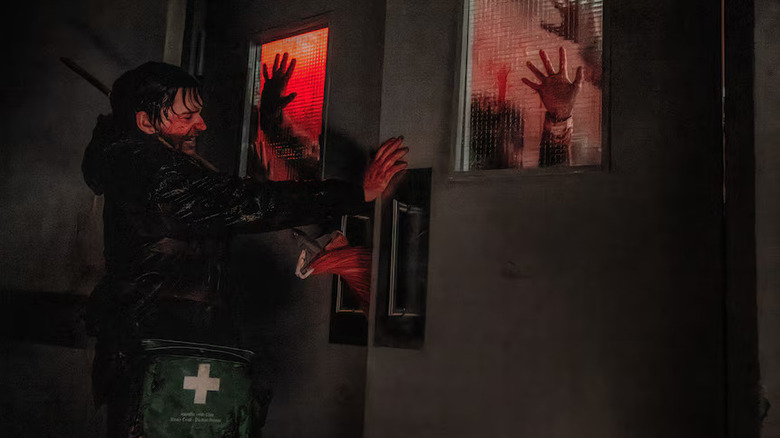 Resident Evil (2026) - Bryan holding door closed to block zombie horde