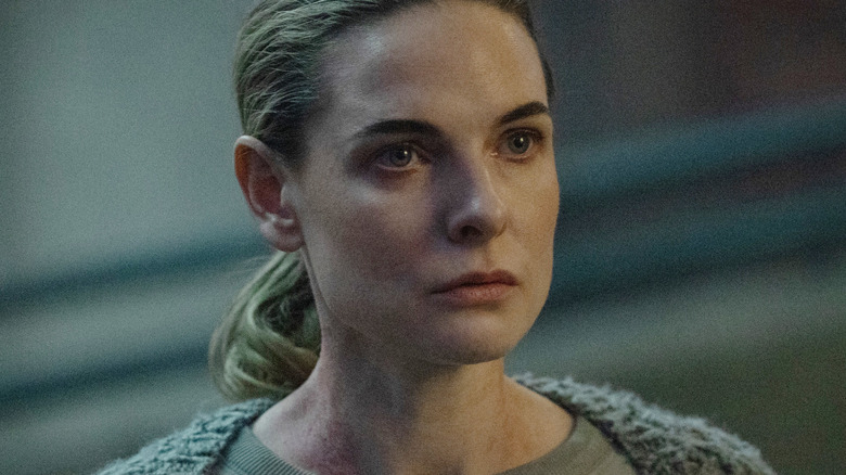 Rebecca Ferguson as Juliette Nichols standing in a dark room wearing a knit sweater in Silo