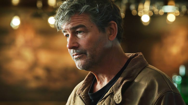 Kyle Chandler's Hal Jordan is seen in closeup standing in a bar in Lanterns