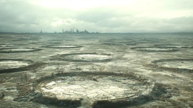 An establishing shot of the devastated surface world with the skyline of Atlanta in the background in Silo