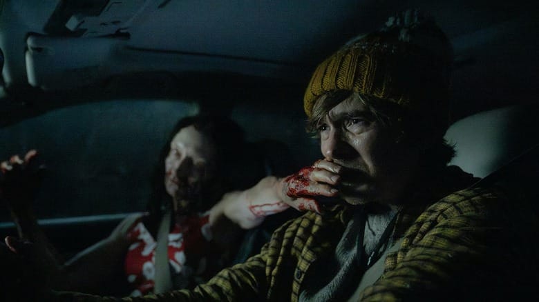 Austin Abrams as Bryan sitting in a car next to a zombie in Resident Evil (2026)