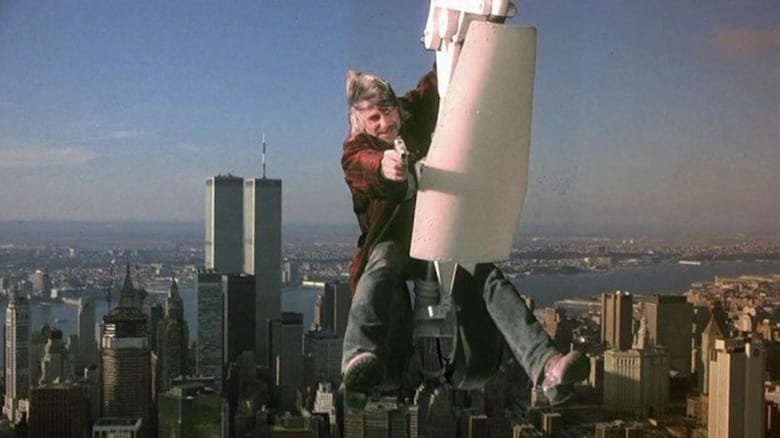 Sam Elliott brandishes a gun while hanging from the landing gear of a plane flying over Manhattan in Stakeout