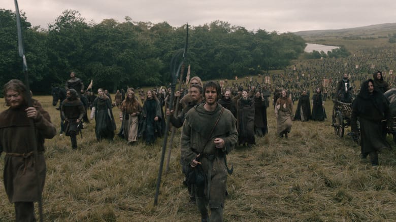 Andrew Garfield as Ploughman walking amid a huge army of peasants in the countryside in The Uprising