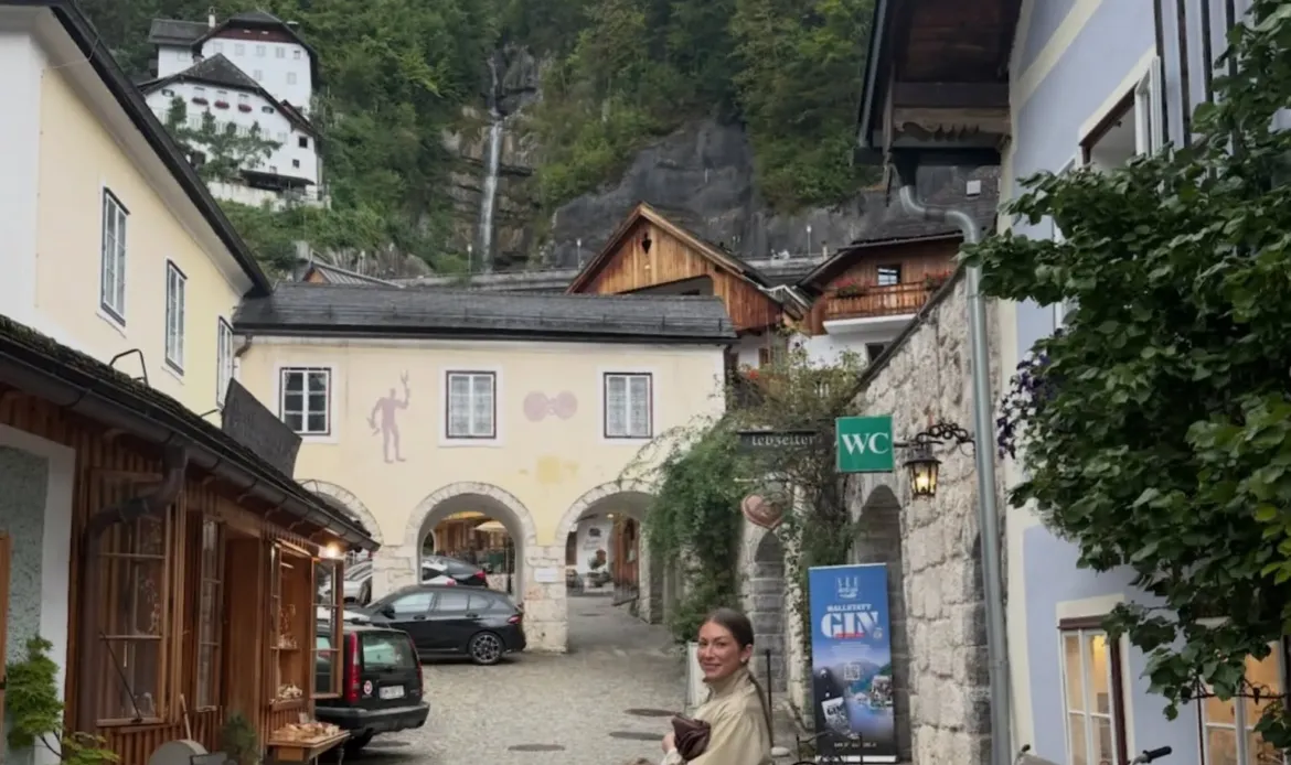 Stassi Schroeder and her daughter in a European village with mountains in the background.