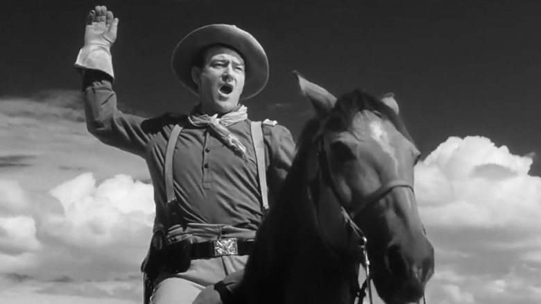 Captain York with his arm up on horseback in Fort Apache