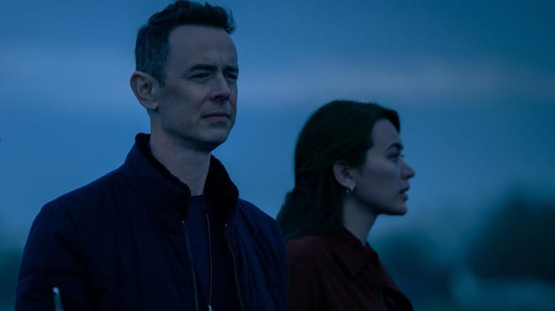 Colin Hanks as Per Stensen standing next to Jessica Henwick as Helen Drew in an open field in Silo