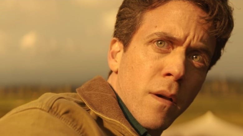 Ashley Zukerman as Daniel Keene watching a nuclear explosion from a distance in Silo