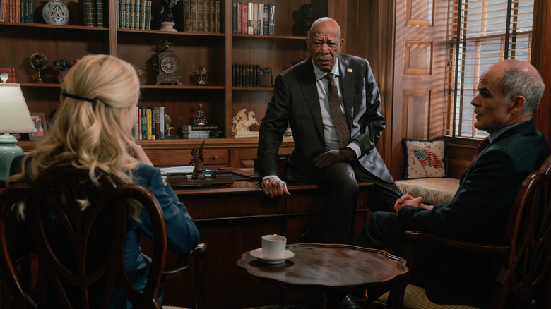 Nicole Kidman's Kaitlyn Meade and Michael Kelly's Byron Westfield sit in the office of Morgan Freeman's Edwin Mullins in Lioness