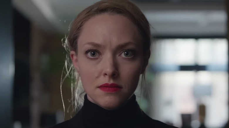 Amanda Seyfried's Elizabeth Holmes stands in a black turtleneck looking into camera in You Can See Everything