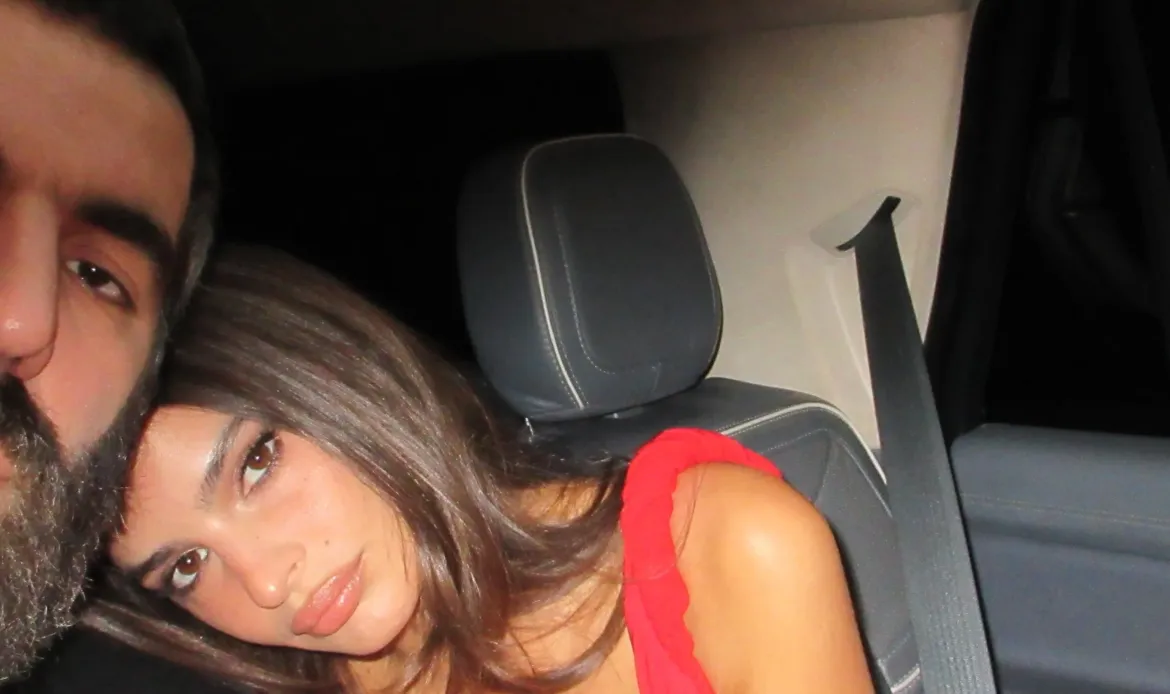 Emily Ratajkowski and Romain Gavras sitting together in the back of a car.