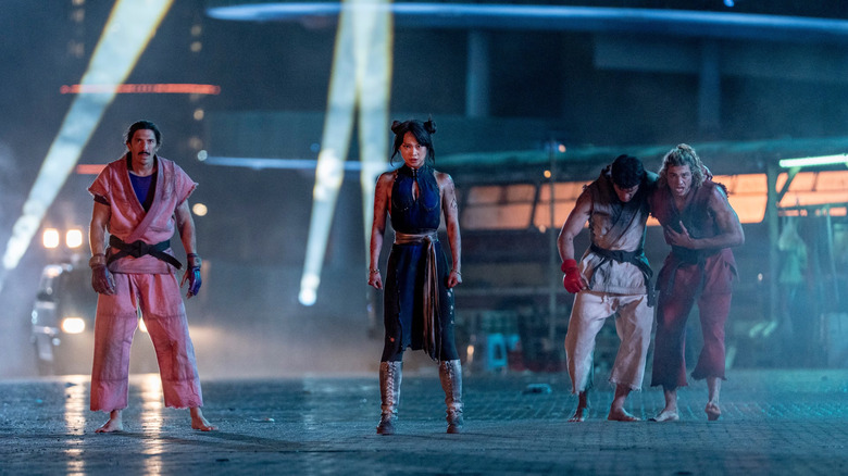 Dan, Chun-Li, Ryu, and Ken pick themselves up at tournament's end in Street Fighter