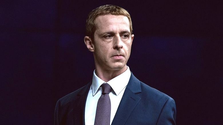 Jeremy Strong as Mark Zuckerberg standing at a podium in The Social Reckoning