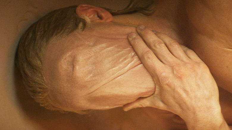 Tom Rhys Harries as Matt Hagen wiping his face away in Clayface