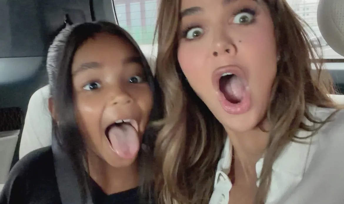Khloe Kardashian and True Thompson making silly faces in the back of a car.