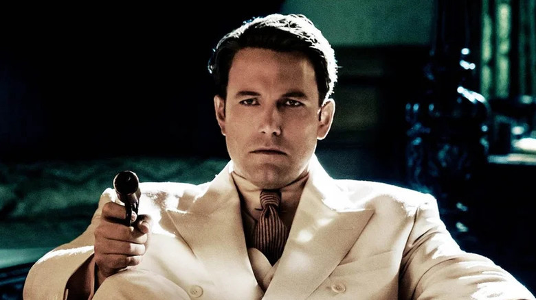 Live By Night poster - Joe Coughlin sitting, in a suit, holding a gun