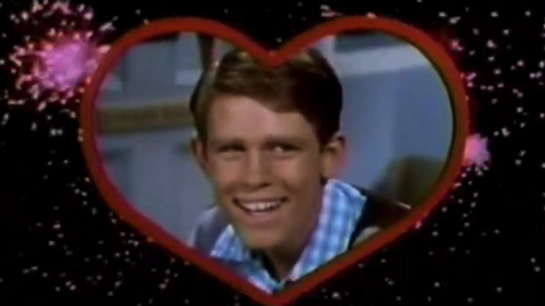 Ron Howard's Richie Cunningham smiles surrounded by a heart graphic in Love, American Style