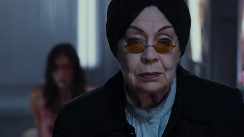 Mademoiselle (Catherine Bégin) stares ahead through her tinted glasses in Martyrs (2008)