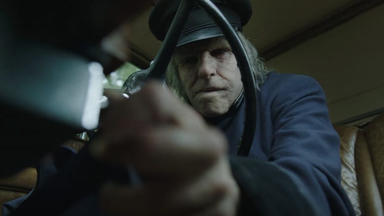 Zachary Quinto's Charlie Manx sits behind the wheel of a car in NOS4A2