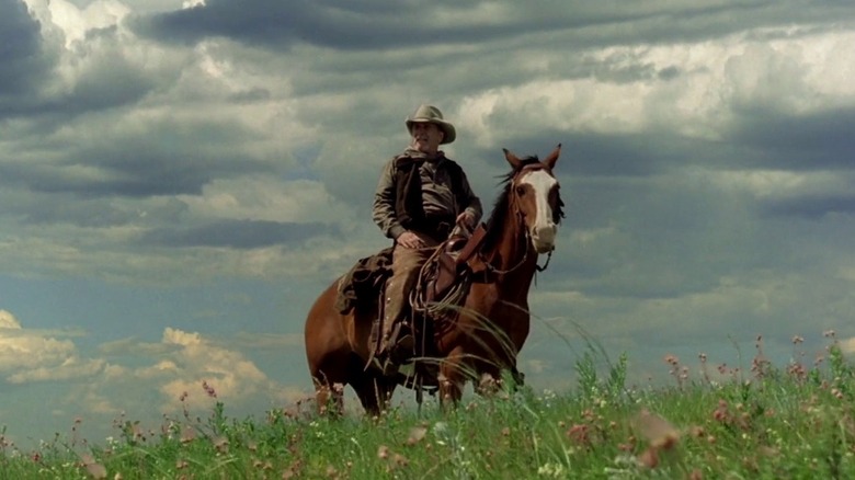 Robert Duvall as Boss Spearman in Open Range, atop a horse in a field against the open sky.
