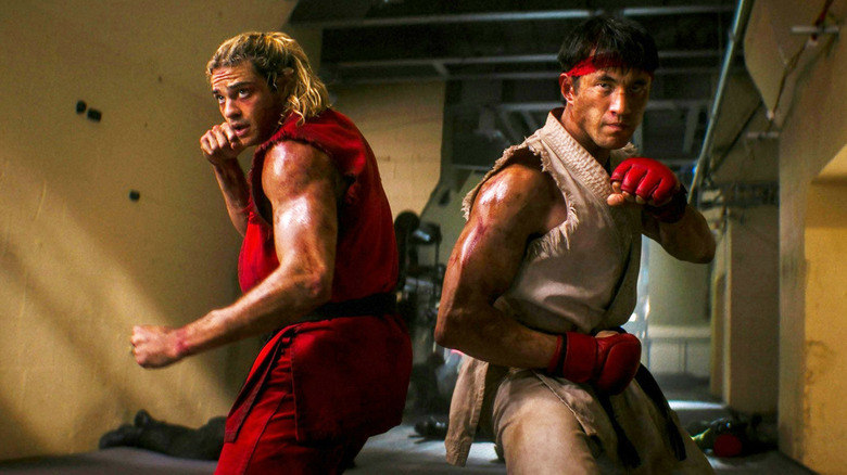 Noah Centineo as Ken standing back to back with Andrew Koji as Ryu with their fists up ready to fight in Street Fighter (2026)