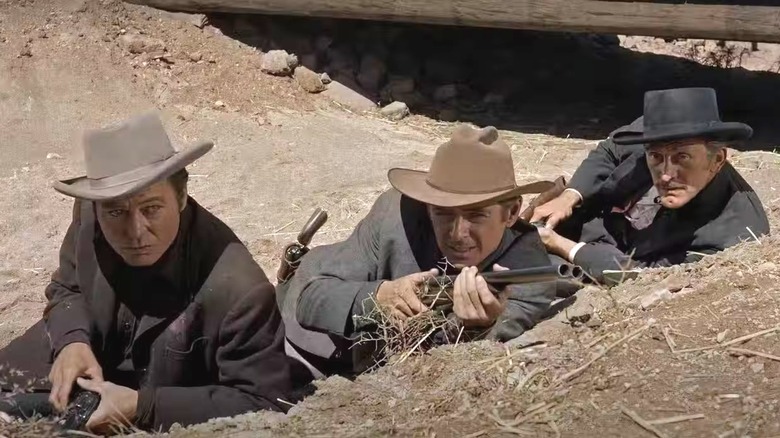 Morgan Earp, Ike, and Doc Holliday with guns in a ditch in Gunfight at the O.K. Corral