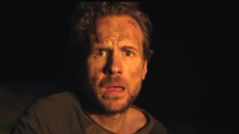 Rafe Spall as Luke with a look of terror on his face at night in The Ritual