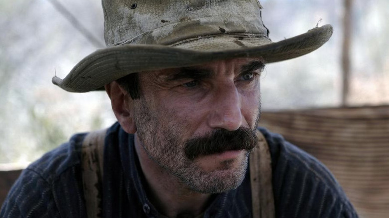 Daniel Day-Lewis as Daniel Plainview in There Will Be Blood, wearing a hat and looking off.