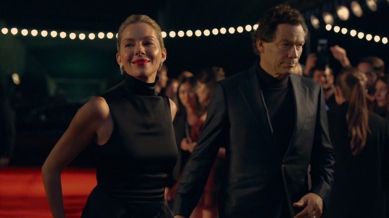 Carla and Morgan on a red carpet dressed formally in War