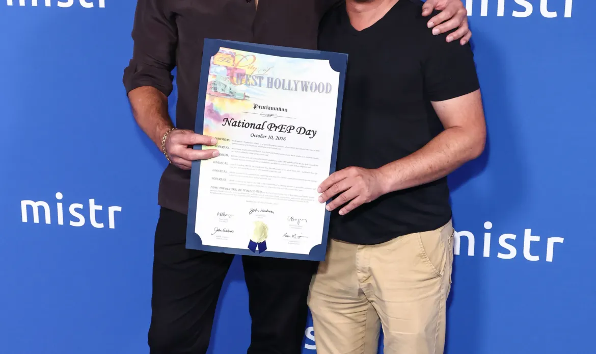 Tristan Schukraft and Danny Hang hold a proclamation for National PrEP Day at MISTR's celebration.