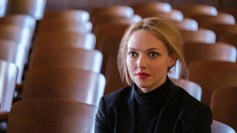 Elizabeth Holmes looking startled in a black turtleneck and red lipstick in The Dropout